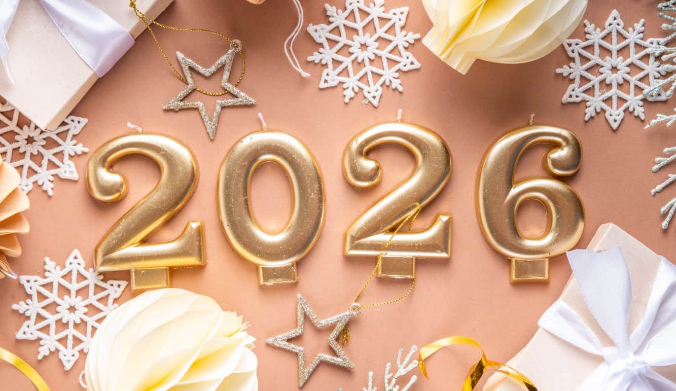 Fireworks lighting up the night sky for Happy New Year 2026 celebration, with people celebrating, toasting, and welcoming the new year with joy and positivity